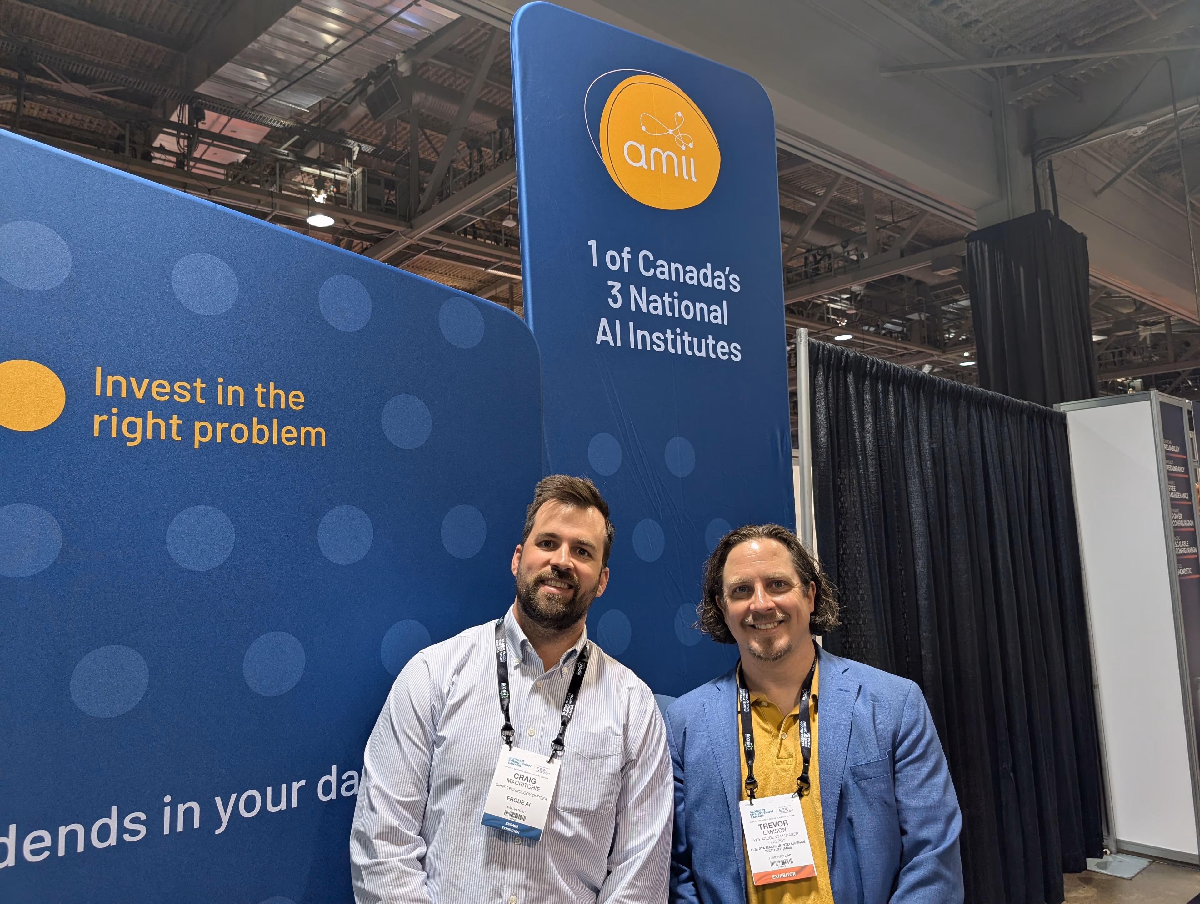 Erode AI CTO Craig MacRitchie with Trevor Lamson of Amii at a trade show booth, in front of a banner reading "1 of Canada’s 3 National AI Institutes"